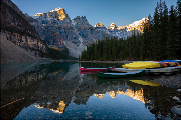 Moraine Lake canoes at sunrise for visitors arriving by shuttle