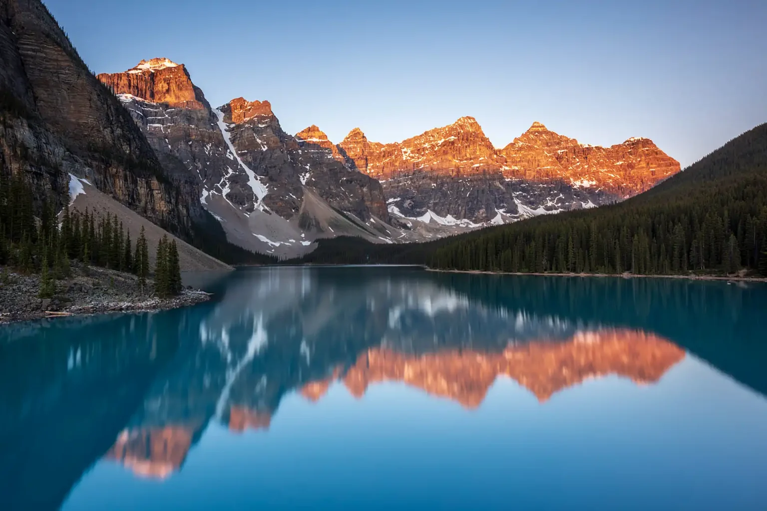 Photographer capturing sunrise at Moraine Lake