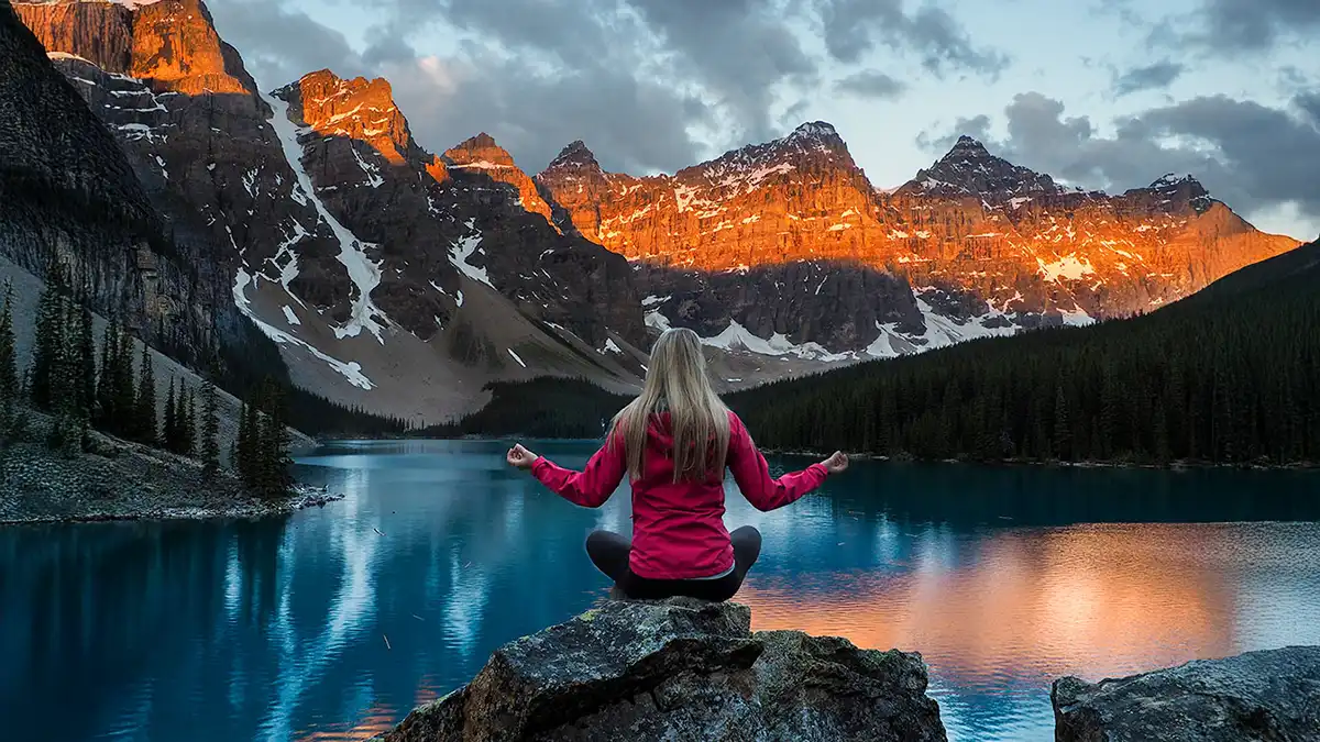 Photographer at Moraine Lake rockpile viewpoint with Valley of Ten Peaks