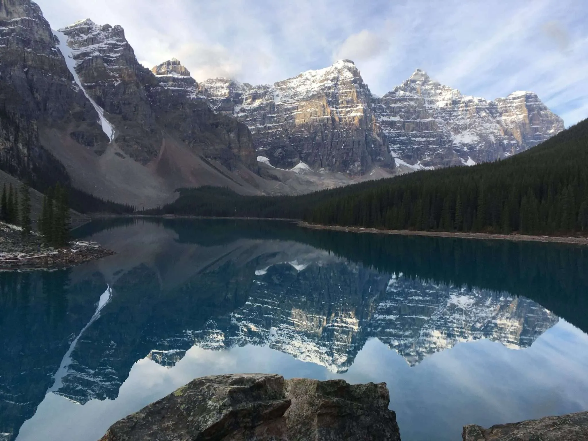Moraine Lake at sunrise with perfect mountain reflections