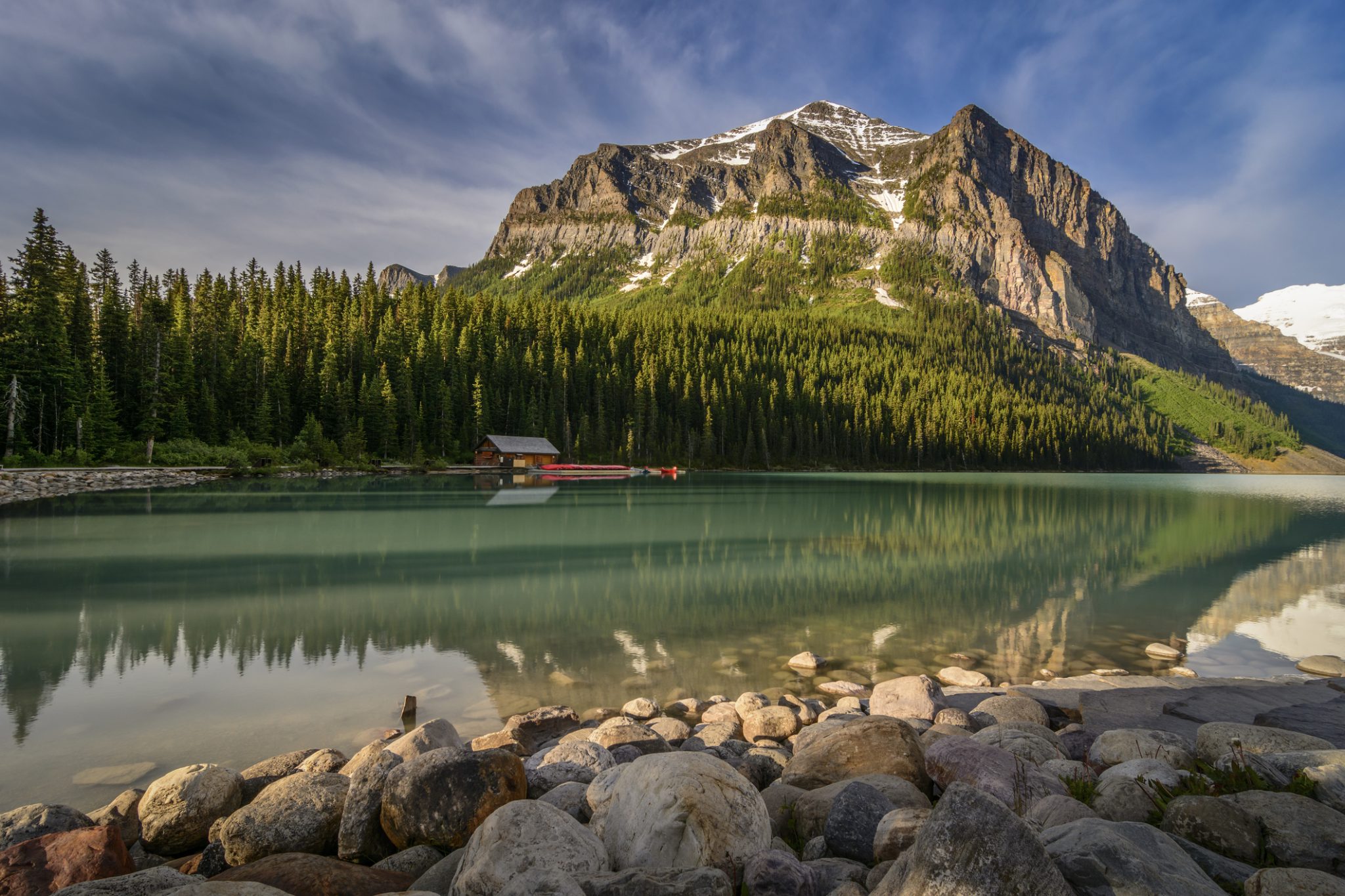 Lake Louise boathouse with turquoise water and Victoria Glacier