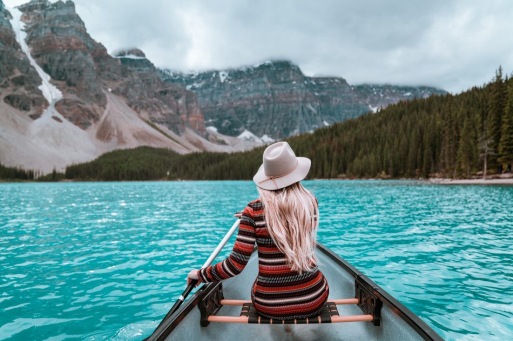 Red canoes on Moraine Lake with the Valley of the Ten Peaks creating a perfect reflection in the turquoise water