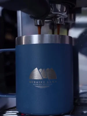 Fresh espresso pouring into a Moraine Lake Sunrise Shuttle mug